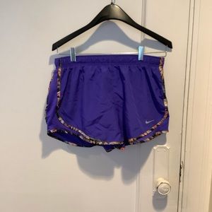Purple Nike shorts with orange and black trim